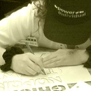 Girl works on bumper sticker design